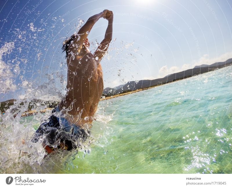 Boy jumping in water, playing and having fun Joy Happy Playing Vacation & Travel Summer Sun Beach Ocean Sports Child Human being Boy (child) Man Adults Nature