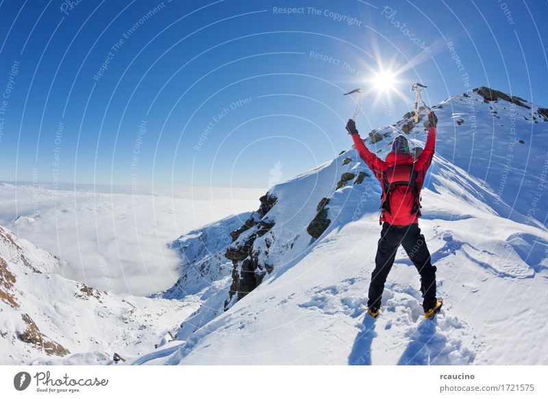 Mountaineer reaches the top of a snowy mountain Adventure Expedition Sun Winter Snow Sports Climbing Mountaineering Success Man Adults Nature Landscape Sky Alps