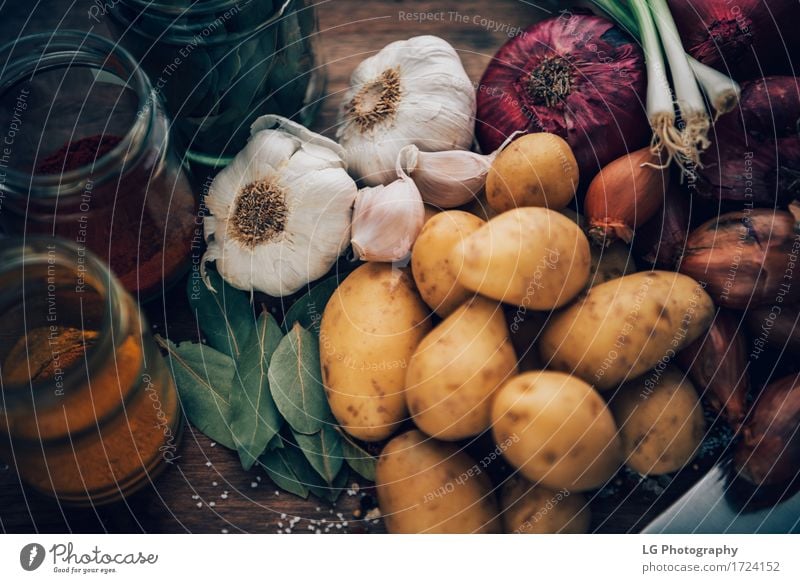 Still life of food staples. Kitchen essentials. Herbs and spices Leaf Fresh Natural Yellow Green Red Colour bay leaves board bulbs colorful cooking flavors