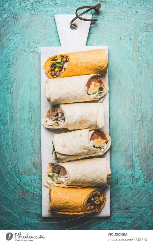 Vegetarian delicious tortilla wraps on cutting board Food Fish Vegetable Lettuce Salad Bread Herbs and spices Nutrition Lunch Dinner Buffet Brunch Banquet