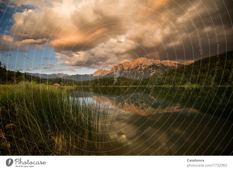 In the evening thundery; clouds in the evening sky, the lake reflects the mountain landscape Mountain Hiking Nature Landscape Storm clouds Horizon Sunrise