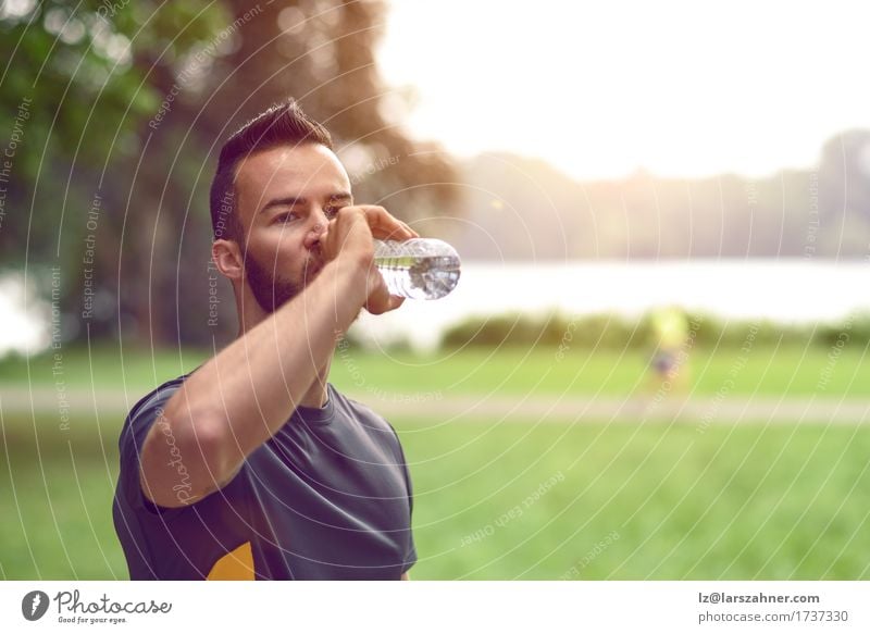 Young man drinking bottled water Drinking Lifestyle Face Summer Masculine Man Adults 1 Human being 18 - 30 years Youth (Young adults) Warmth Beard Fitness