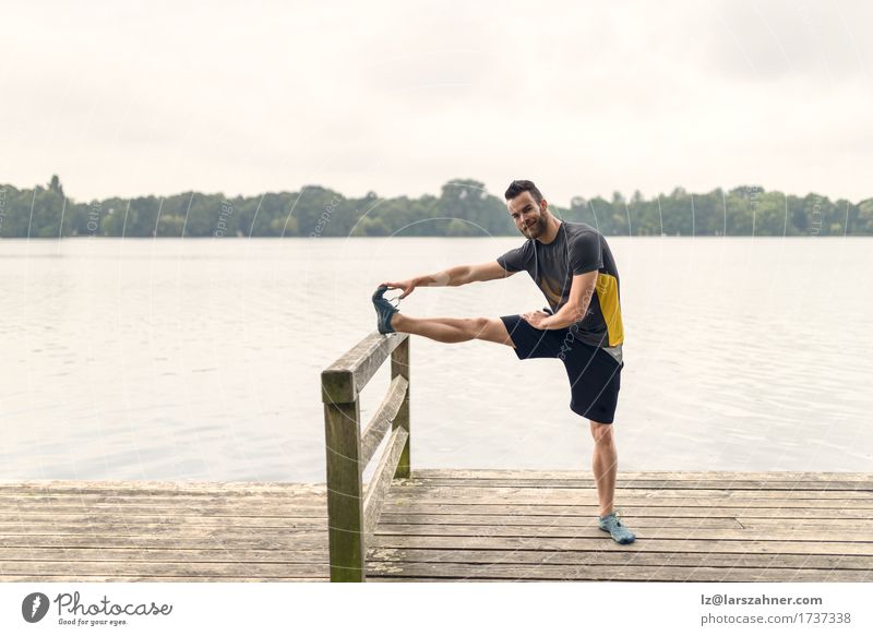 Young man doing stretching exercises Lifestyle Body Face Summer Sports Masculine Man Adults 1 Human being 18 - 30 years Youth (Young adults) Warmth Lake Beard