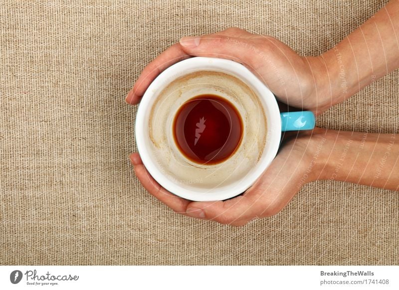 Two woman hands holding big empty finished black coffee cup To have a coffee Beverage Hot drink Coffee Mug Woman Adults Hand To hold on Embrace Blue Black White