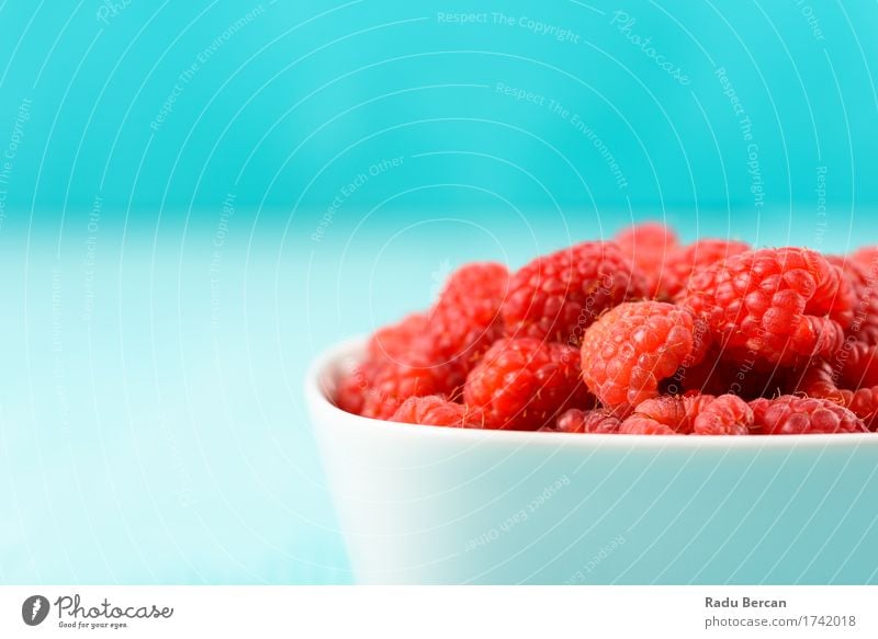 Red Raspberries In Bowl On Turquoise Background Food Fruit Nutrition Eating Breakfast Organic produce Vegetarian diet Diet To feed Feeding Simple Healthy Clean