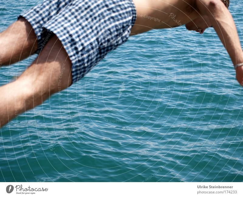 Young man in swimming trunks jumping into the lake Colour photo Exterior shot Copy Space bottom Day Sunlight Joy Wellness Summer Waves Human being Masculine