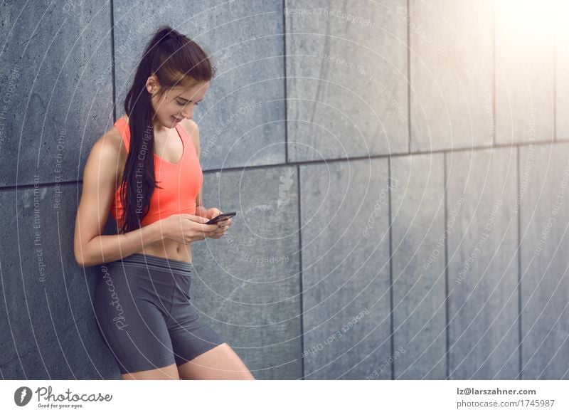 Sporty young woman with smartphone Face Summer Telephone PDA Feminine Young woman Youth (Young adults) Woman Adults 1 Human being 18 - 30 years Warmth Brunette