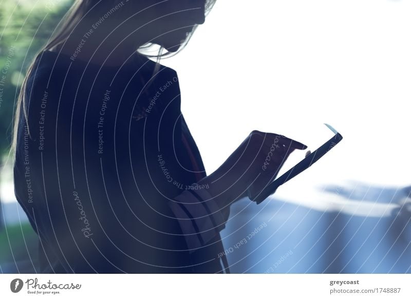 Silhouette of a woman using touchpad. Shot on bright light background Computer Technology Human being Girl Young woman Youth (Young adults) 1 18 - 30 years