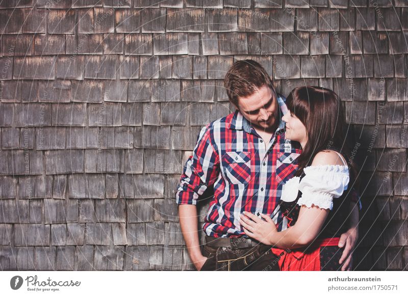 Young couple in traditional costume in front of a mountain hut Style Tourism Oktoberfest Dance Human being Masculine Feminine Young woman Youth (Young adults)