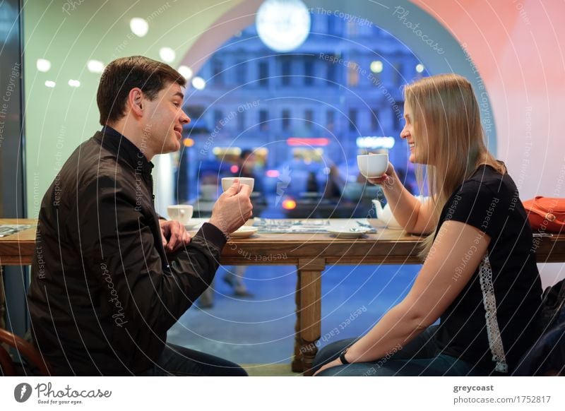 Man and woman chatting over a cup of coffee inside a cafe or restaurant Beverage Hot drink Coffee Tea Relaxation Restaurant Meeting To talk Human being