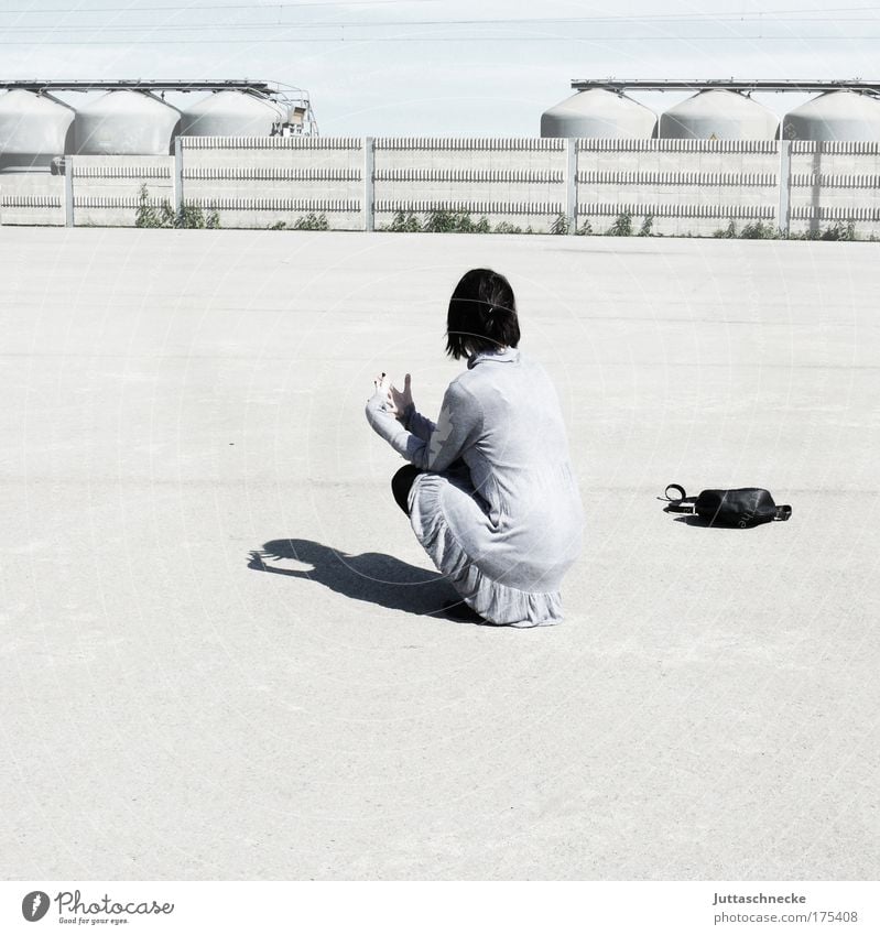 sit and wait Woman Bright Gray Sun Shadow Contrast Wait Crouch Sit Loneliness Bag Handbag Concrete Places Industrial site Back Break Calm Peace squat Dress