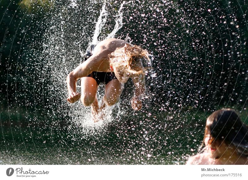 water acrobatics Colour photo Exterior shot Day Sunlight Shallow depth of field Full-length Closed eyes Joy Playing Aquatics Jump Water Drops of water Summer