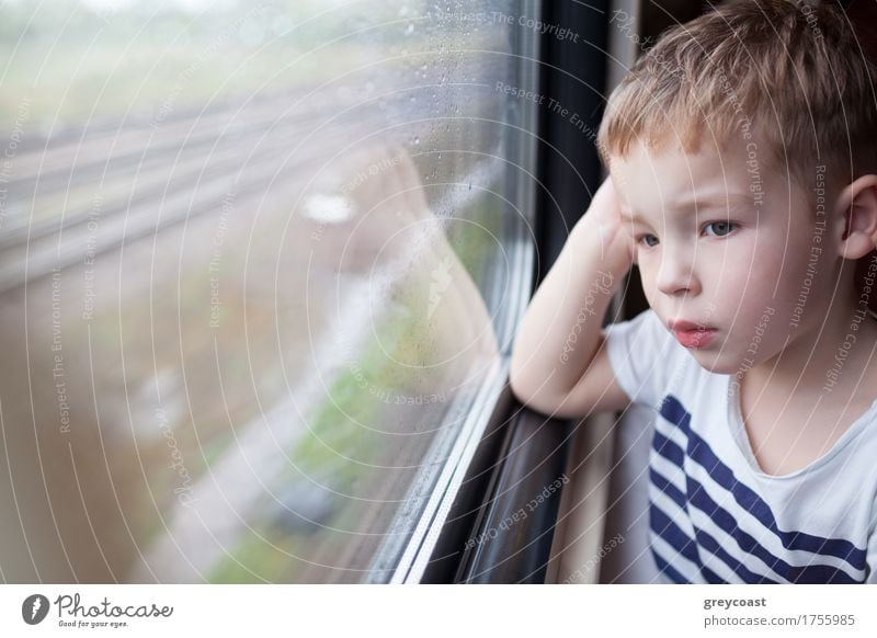 Curious boy looking out the window of a speeding train Vacation & Travel Trip Child Human being Boy (child) 1 1 - 3 years Toddler Weather Rain Transport