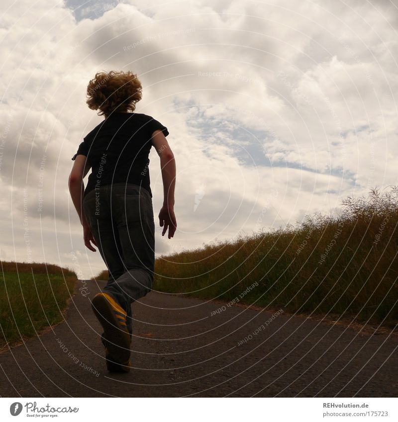 Young man running in a street Colour photo Exterior shot Copy Space right Day Contrast Silhouette Full-length Looking away Human being Masculine