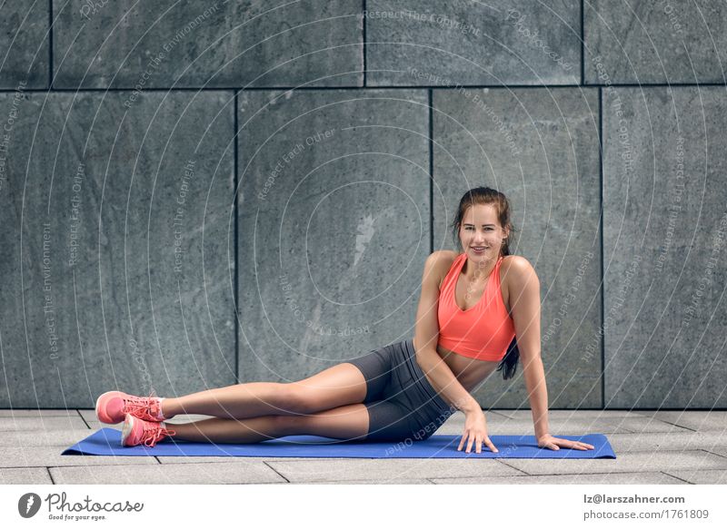 Fit young woman sitting up on yoga mat Lifestyle Happy Body Face Summer Sports Woman Adults 1 Human being 18 - 30 years Youth (Young adults) Brunette Fitness