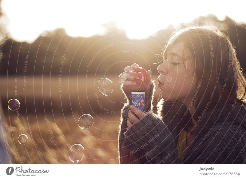 Make a wish. Colour photo Subdued colour Exterior shot Copy Space left Copy Space top Morning Sunlight Back-light Portrait photograph Profile Closed eyes