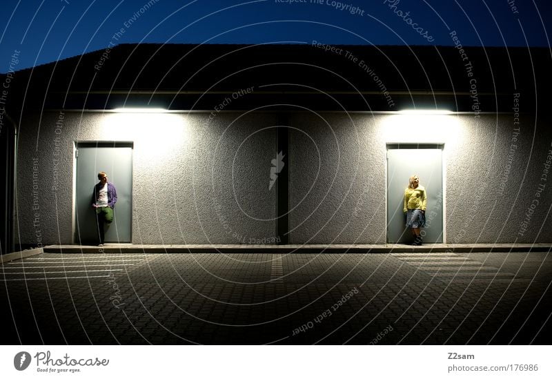 twosome Colour photo Exterior shot Evening Night Artificial light Deep depth of field Human being Masculine Couple 2 Architecture Door Street Blonde Stand Wait