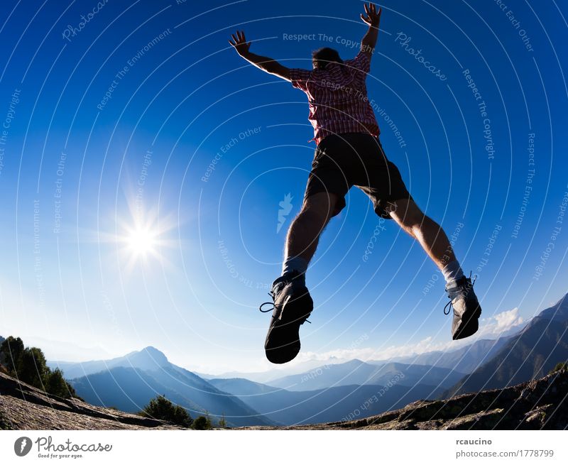 Man jumping in the sunshine against blue sky. Lifestyle Joy Relaxation Vacation & Travel Freedom Summer Sun Mountain Success Adults Landscape Sky Clothing Shirt