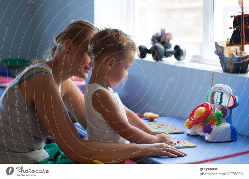 Mother watching little son playing learning game in his room Joy Playing Parenting Child Boy (child) Young woman Youth (Young adults) Adults Family & Relations