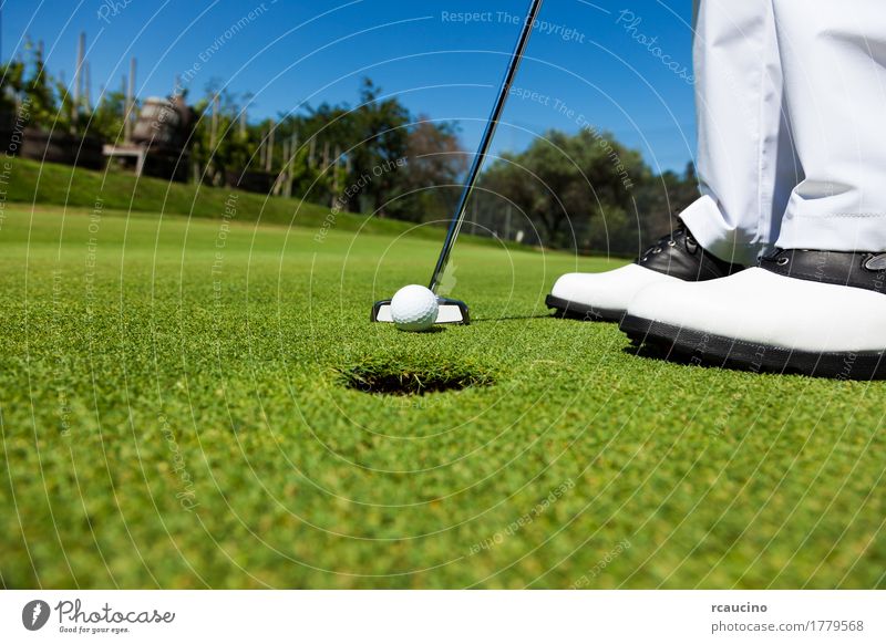 Golfer on the putting green, preparing to put Joy Relaxation Playing Summer Sports Golf course Man Adults Feet Pants Footwear Stand Green White Loneliness ball