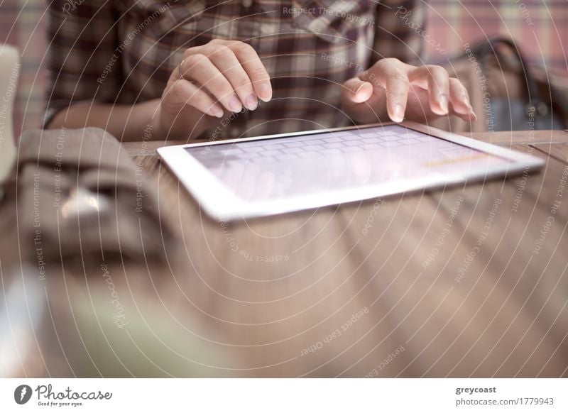 Close-up shot of woman typing on tablet computer sitting at the wooden in cafe Table Computer Internet Human being Young woman Youth (Young adults) Hand Places