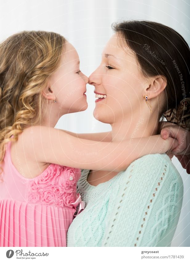 Beautiful mother and daughter touching each other with their noses. Lovely family portrait Joy Happy Playing Child Human being Girl Young woman