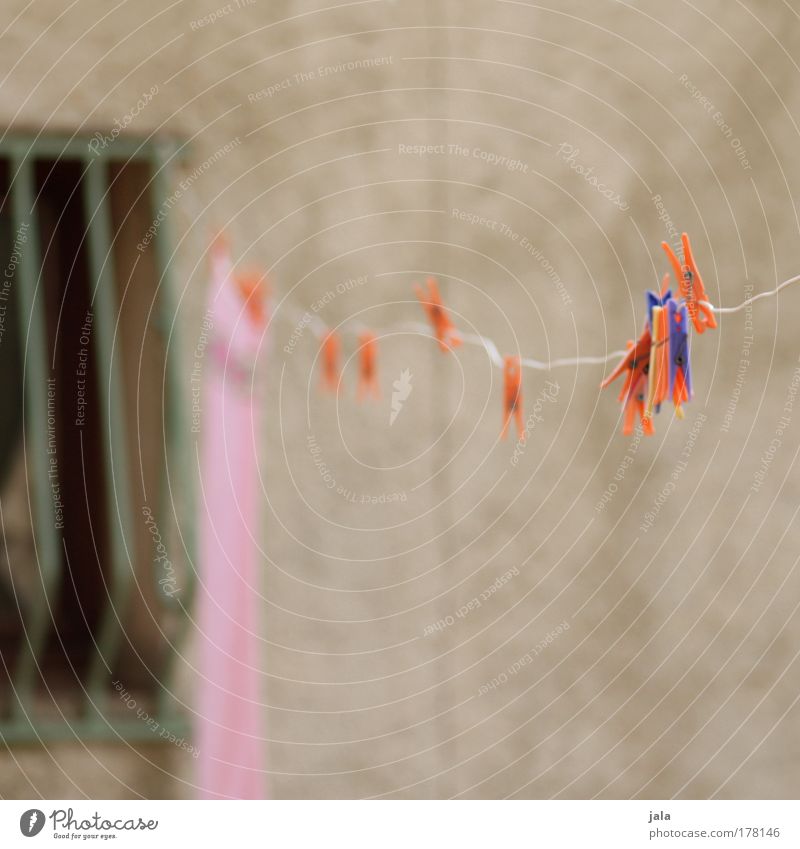 left hanging Colour photo Exterior shot Deserted Laundry Clothesline Clothes peg Window Facade Grating Blue Red Orange Hang Pink Day