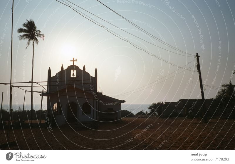 Church in 1a-Lage Colour photo Subdued colour Exterior shot Silhouette Back-light Tourism Landscape Sky Palm tree Coast India - Goa Asia Deserted