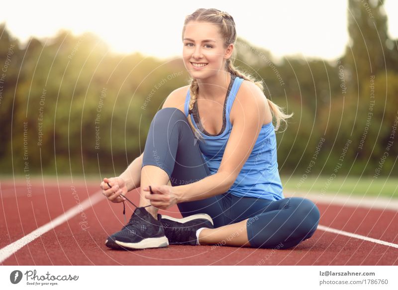 Sporty young woman tieing her laces Lifestyle Beautiful Summer Sun Sports Woman Adults 1 Human being 18 - 30 years Youth (Young adults) Warmth Footwear Blonde