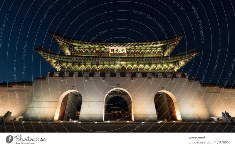 Low angle shot of the illuminated three-portal Gwanghwamun Gate at night. Landmarks of Seoul, South Korea Vacation & Travel Tourism Sightseeing Town