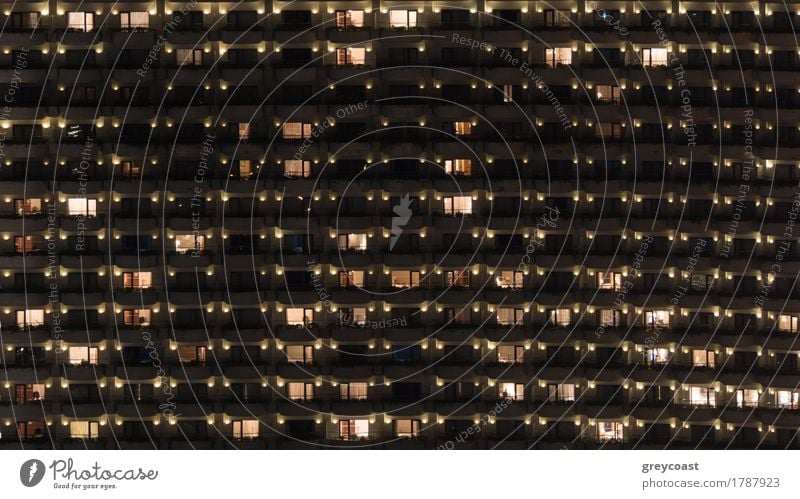 Facade of highrise apartment block with balconies. Electric lights in some windows. Housing in Bangkok, Thailand Flat (apartment) House (Residential Structure)