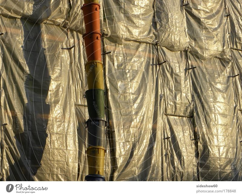 Rainbow vs. debris Colour photo Exterior shot Copy Space right Evening Light Reflection Central perspective Construction site Closing time Facade Plastic Hang