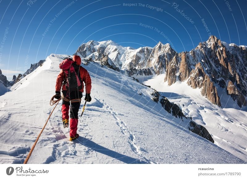 Mountaneer climbs a snowy ridge in Mont Blanc, France Adventure Expedition Sun Winter Snow Mountain Sports Climbing Mountaineering Success Man Adults Nature