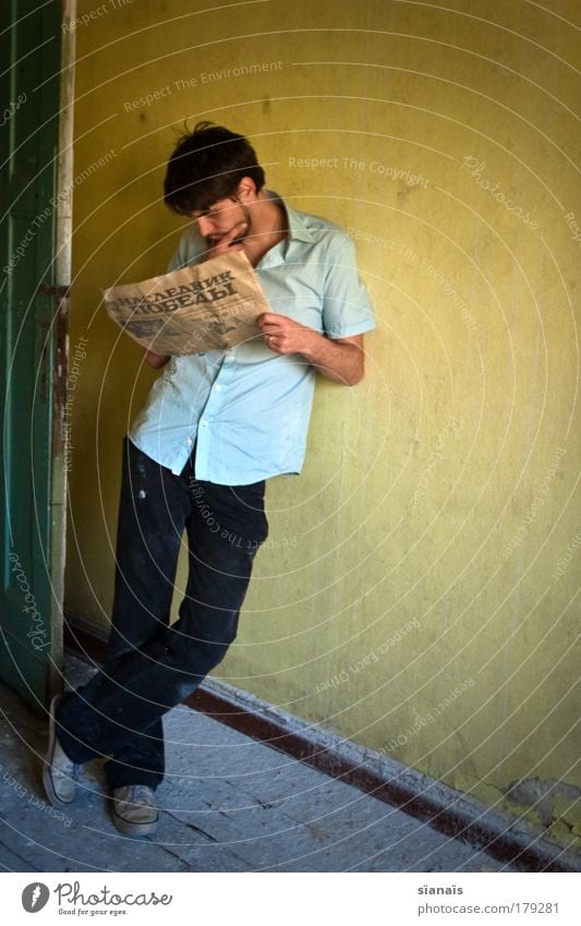 russian bread Colour photo Subdued colour Wide angle Full-length Downward Human being Masculine Young man Youth (Young adults) Man Adults 1 Reading Stand