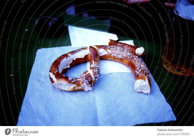 pretzel Food Dough Baked goods Going out Drinking Fairs & Carnivals Beer garden Blue Brown Pretzel Colour photo Subdued colour Exterior shot Day Shadow Contrast