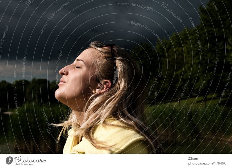 epicure Colour photo Exterior shot Sunbeam Deep depth of field Closed eyes Hunting Human being Feminine Head Hair and hairstyles Nature Landscape Storm clouds