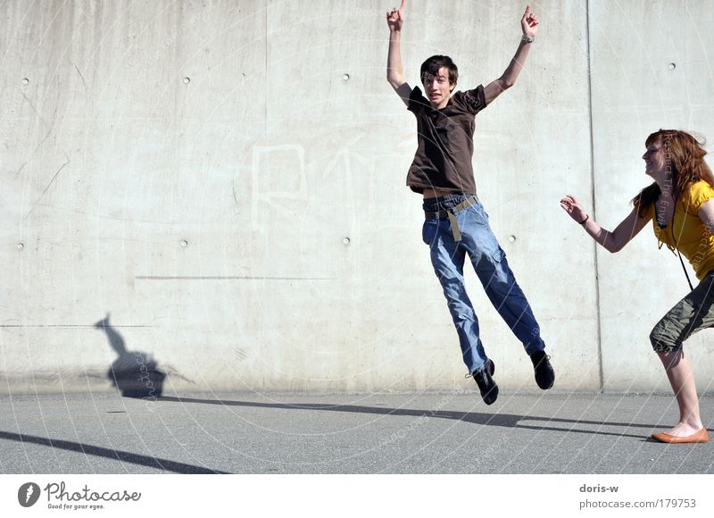 hop around Joy Happy Masculine Young woman Youth (Young adults) Young man Friendship Couple Partner T-shirt Jeans Red-haired Short-haired Long-haired Movement