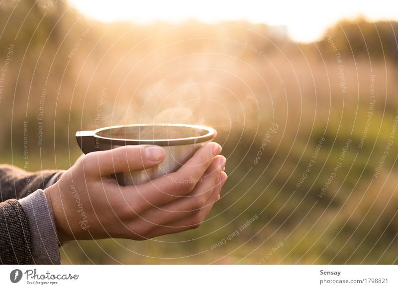 Thermos cup in hand on autumn background Coffee Tea Joy Sun Human being Woman Adults Hand Nature Autumn Street Hot thermos flask vacuum Seasons drink cold young