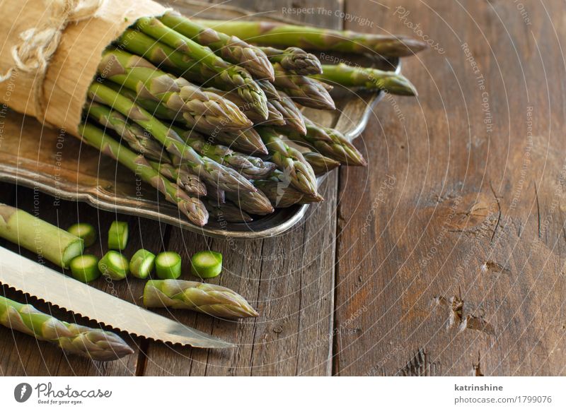 Fresh asparagus with knife Vegetable Nutrition Dinner Vegetarian diet Knives Table Healthy Natural Brown Green Asparagus food Gourmet wood Sliced health