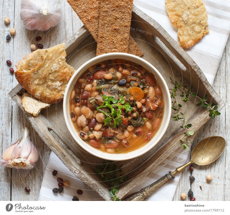 Cooked legumes and vegetables in a bowl Vegetable Bread Soup Stew Herbs and spices Nutrition Vegetarian diet Bowl Spoon Wood Delicious Natural Brown Green Red