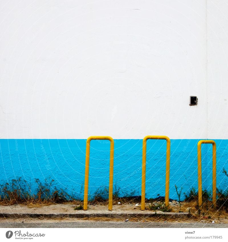 bicycle stands Multicoloured Detail Deserted Copy Space top Deep depth of field Central perspective Wall (barrier) Wall (building) Facade Metal Authentic Simple