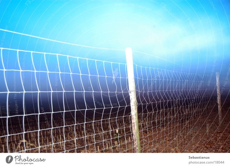 Fence at dusk Twilight Long exposure Field Dusk Fence post Sky Back-light Wire netting Wire netting fence Boundary Deserted Exterior shot