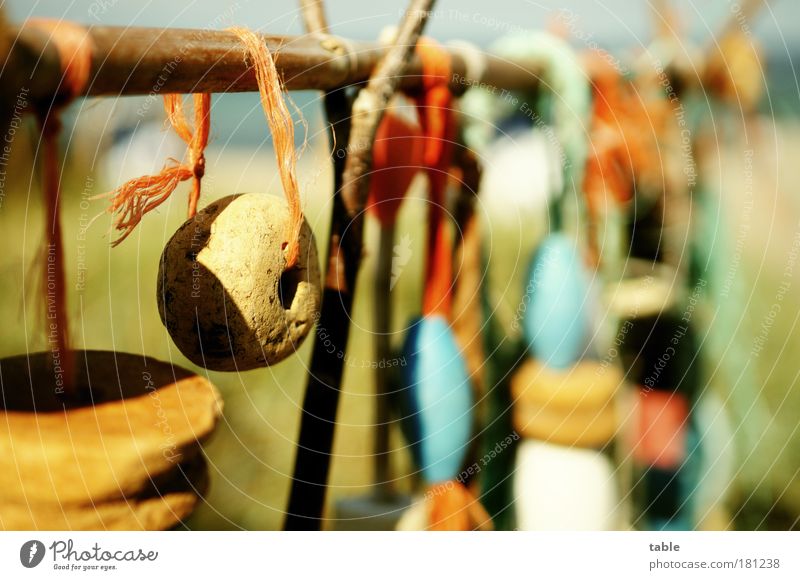 rubbish Colour photo Close-up Detail Deserted Sunlight Shallow depth of field Souvenir Stone Wood Hang To swing Old Trashy Blue Brown Multicoloured Red Black