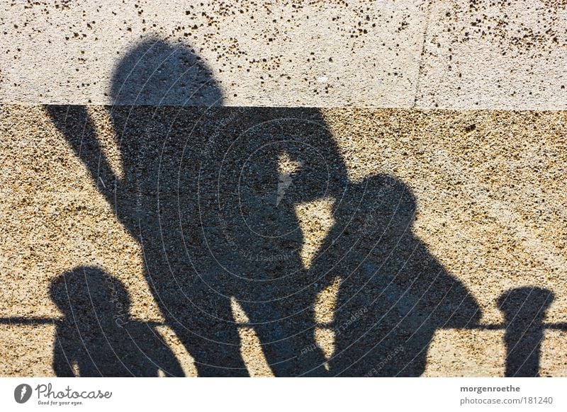 puppets Colour photo Exterior shot Experimental Day Sunlight Human being Child Man Adults 3 Group Sign Observe To enjoy Warmth Brown Black