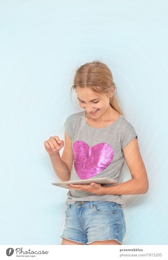 Close shot of girl using a mobile device Joy School Classroom Schoolchild Notebook Girl 1 Human being Think Happiness Optimism Passion Education Resolve Success