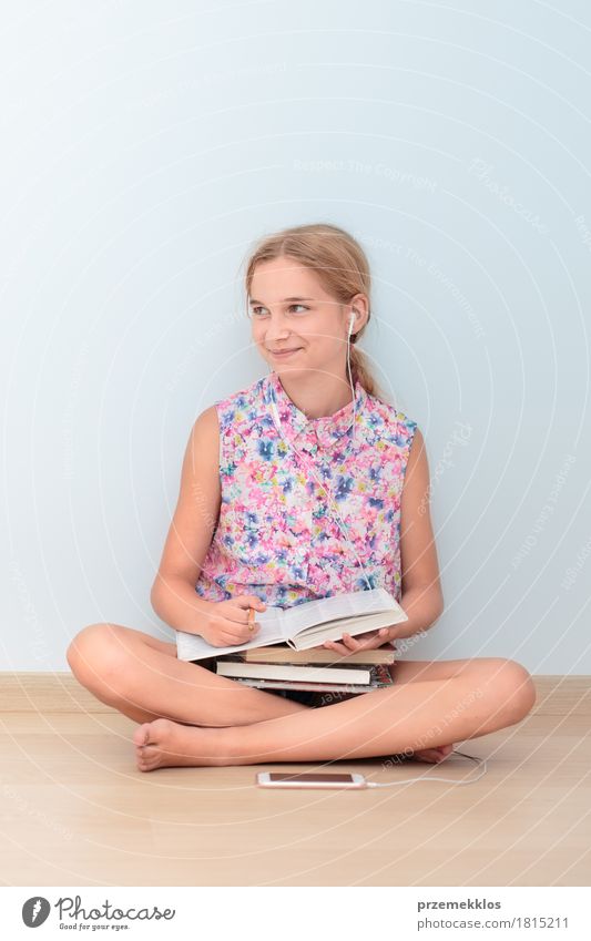 Schoolgirl reading a book in classroom Lifestyle Reading Education Classroom Schoolchild Academic studies University & College student Workplace Cellphone