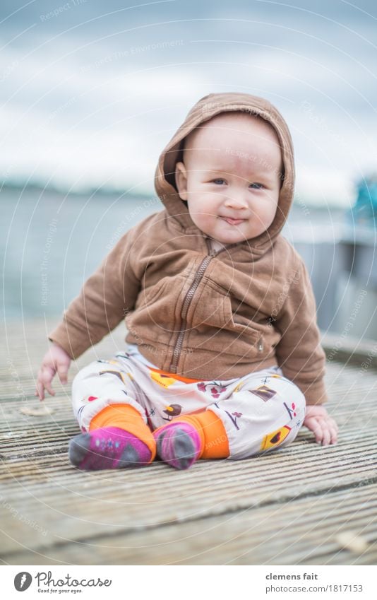 family happiness Baby Exterior shot Footbridge Water Family & Relations Child Sit Covered Brown Looking Innocent