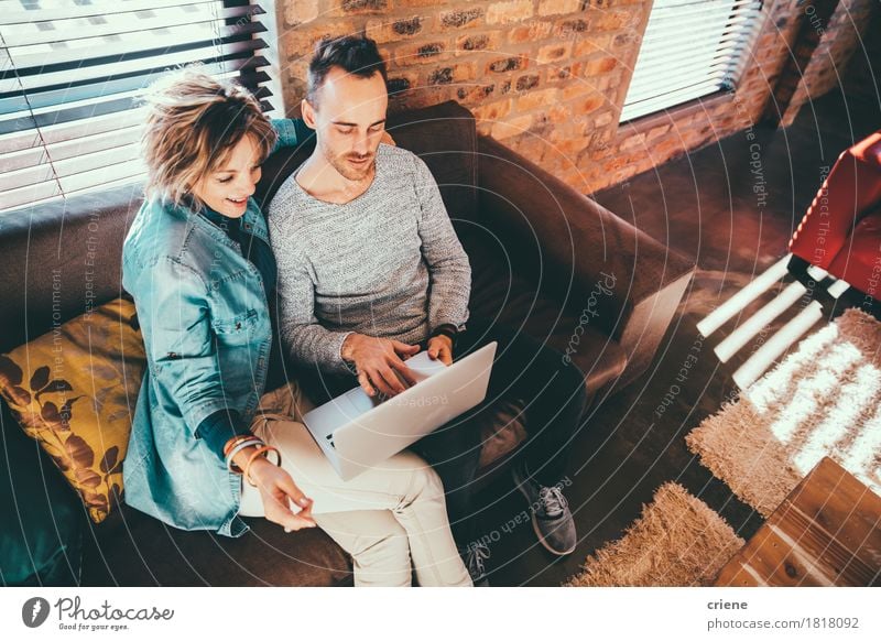 Son is showing his mother a picture on laptop Lifestyle Joy House (Residential Structure) Living room School Business Notebook Screen Technology Human being Man