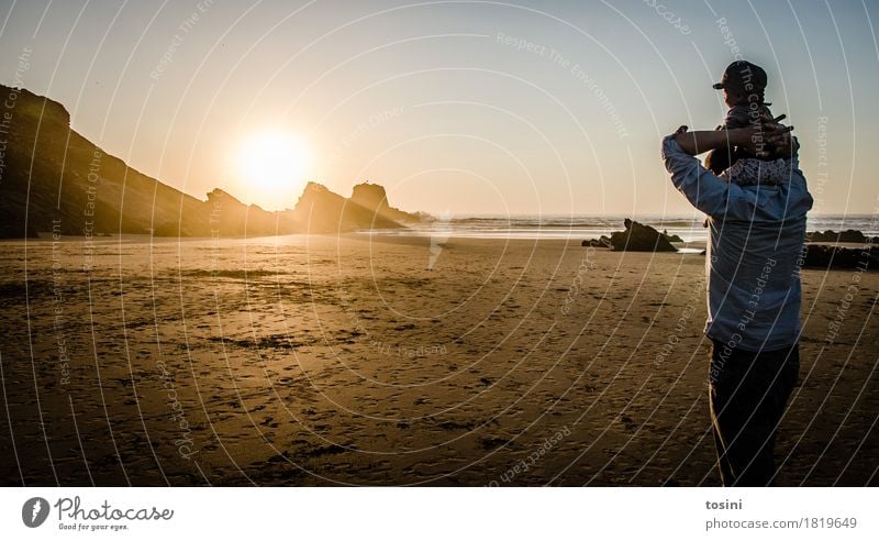 Father has son on shoulder on beach in sunset Ocean Water Reflection Sun Light Evening Evening sun Sand Beach Dusk Vacation & Travel Relaxation Longing Lighting