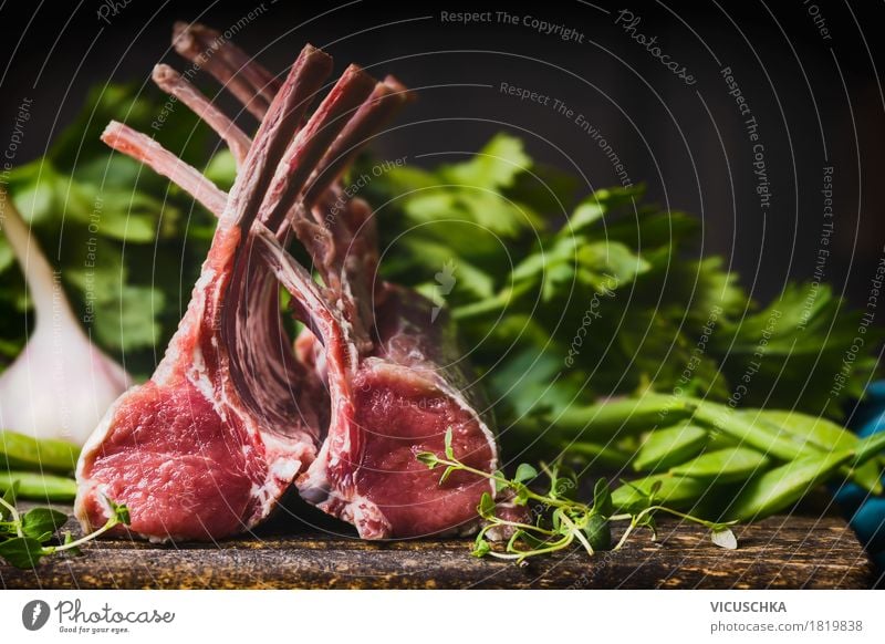 Lamb Racks on kitchen table with green ingredients Food Meat Vegetable Herbs and spices Nutrition Lunch Dinner Banquet Organic produce Style Design